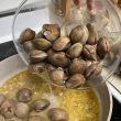 Adding clams to pan