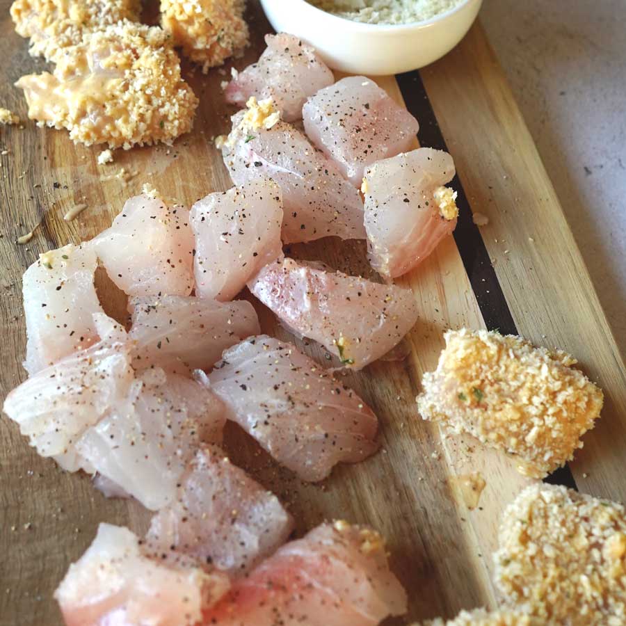Snapper nuggets half covered with bater and breadcrumbs