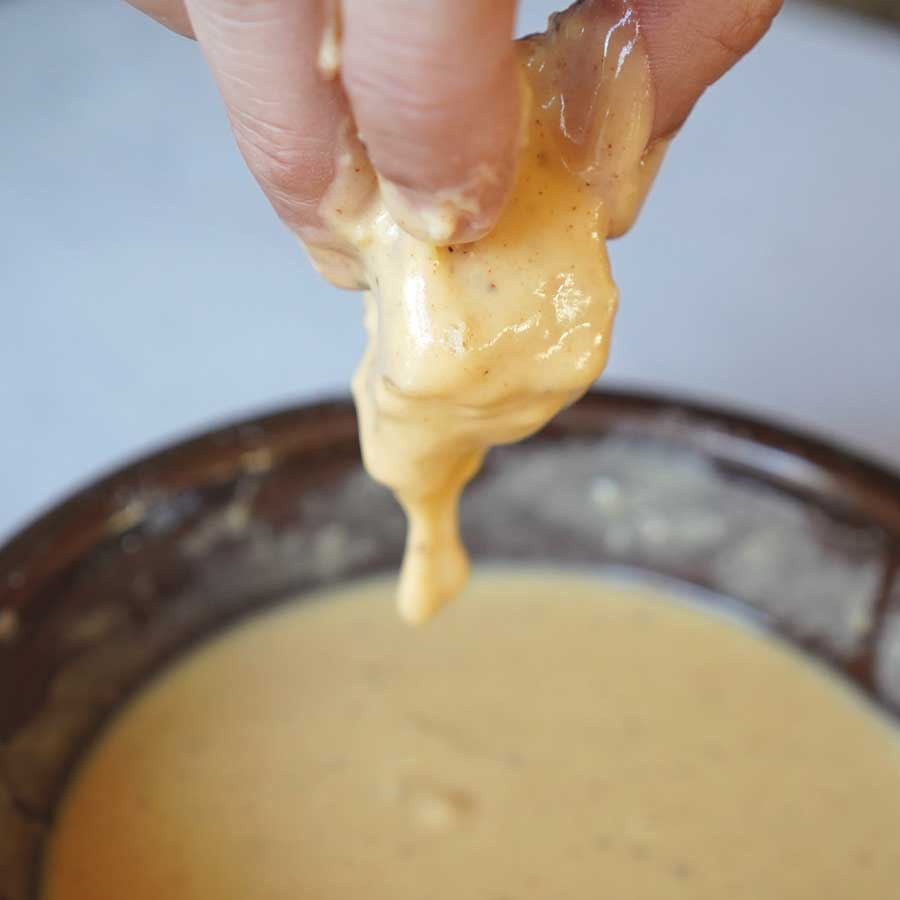 Dipping nugget into batter